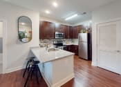Thumbnail 3 of 39 - a kitchen with an island and stools at The Bend Arbordale, Virginia, 23188