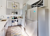 Thumbnail 4 of 40 - a kitchen with stainless steel appliances and white counter tops at The Cottages at Old Monrovia Apartment , Huntsville, Alabama