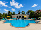 Thumbnail 19 of 36 - A large swimming pool with a waterfall feature in the middle.