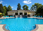 Thumbnail 20 of 36 - A pool with a fountain in the middle of it.
