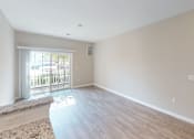 Thumbnail 20 of 33 - a bedroom with hardwood flooring and a door leading to a balcony at The Landing Apartment , New Jersey, 07730
