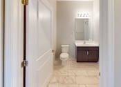 Thumbnail 22 of 33 - a bathroom with a toilet sink and mirror at The Landing Apartment , New Jersey