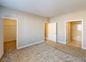 Thumbnail 19 of 33 - a bedroom with a closet and a door to a bathroom at The Landing Apartment , Hazlet, 07730