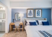 Thumbnail 13 of 35 - a bedroom with blue walls and a white bed with blue and white bedding at The Lotus at Village Walk, Fort Myers, Florida