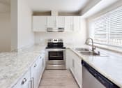 Thumbnail 2 of 23 - a kitchen with white cabinets and a large window