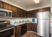 Thumbnail 1 of 13 - Kitchen at Village Gardens Apartments in Fort Collins, CO