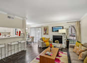 Thumbnail 2 of 32 - A living room with a fireplace and a couch.