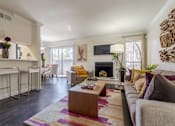 Thumbnail 8 of 22 - A living room with a fireplace and a couch.at 2400 Briarwest Apartments, Texas, 77077