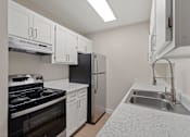 Thumbnail 13 of 27 - Kitchen with white cabinets and a black stove and refrigerator at Verde Apartments in Tucson, 85719
