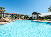 Thumbnail 20 of 25 - Swimming Pool with Leasing Office in Background  at Legacy Brooks, San Antonio, TX, 78223