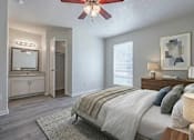 Thumbnail 11 of 11 - A bedroom with a large bed and a ceiling fan.