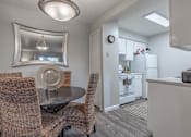 Thumbnail 3 of 11 - Dining area with a table and chairs and a kitchen in the background  at Riverstone, Bryan, TX
