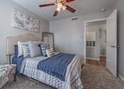 Thumbnail 8 of 11 - Bedroom with a bed and a ceiling fan  at Riverstone, Bryan, TX, 77802