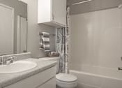 Thumbnail 9 of 11 - Bathroom with a sink toilet and shower  at Riverstone, Bryan, Texas