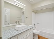 Thumbnail 21 of 25 - A white bathroom with a sink, toilet, and bathtub at San Xavier Casitas, Tucson, AZ