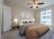Thumbnail 13 of 26 - A bedroom with a large bed and a ceiling fan.