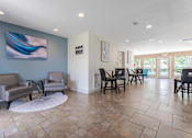 Thumbnail 16 of 26 - A living room with a blue wall and a painting on it.