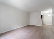 Thumbnail 24 of 26 - A room with wooden flooring and white walls.