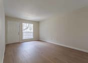 Thumbnail 26 of 26 - A room with a white door and a window with blinds.