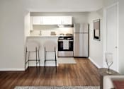 Thumbnail 2 of 17 - A kitchen with a refrigerator, oven, and sink is visible.