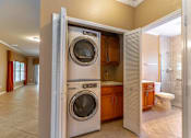 Thumbnail 5 of 15 - a bathroom with a washer and a dryer in a laundry room