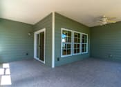 Thumbnail 10 of 15 - the covered porch has a ceiling fan and a door to the patio