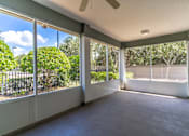 Thumbnail 11 of 15 - an empty living room with large windows and a tile floor