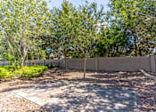 Thumbnail 14 of 15 - a courtyard with a fence and trees in front of it