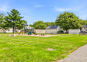 Thumbnail 34 of 52 - A park with a playground and a walking path.