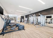 Thumbnail 52 of 87 - A gym with treadmills, weights, and exercise machines. at Axis at Lakeshore, Massachusetts