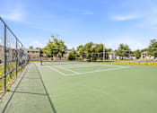 Thumbnail 37 of 52 - A tennis court surrounded by a fence.