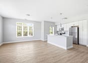 Thumbnail 76 of 87 - A kitchen with a white counter and wooden floors.