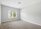 Thumbnail 72 of 87 - A room with a window and carpeted floor.