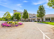 Thumbnail 86 of 87 - A large building with a driveway in front of it.
