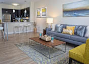 Thumbnail 7 of 35 - A modern living room with a Blue couch and a coffee table at Axis at Lakeshore Apartments, Massachusetts, 02324