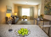 Thumbnail 8 of 35 - A bowl of green apples sits on a table in a well-lit room at Axis at Lakeshore Apartments, Bridgewater, MA 02324