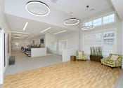 Thumbnail 29 of 35 - A spacious room with wooden floors and white walls at Axis at Lakeshore Apartments, Massachusetts, 02324