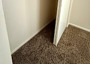 Thumbnail 14 of 18 - a walk in closet in a basement with a sliding door at Hidden Brook Apartment Homes Apartments, Massachusetts, 02740