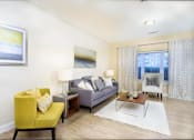 Thumbnail 5 of 35 - A living room with a yellow chair and a grey couch at Axis at Lakeshore Apartments, Bridgewater