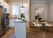 Thumbnail 5 of 18 - Kitchen with Breakfast Bar at Amerige Pointe Apartments, Fullerton, CA