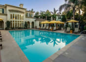 Thumbnail 14 of 18 - Resort Style Pool with Al-Fresco Dining and Fireplace at Amerige Pointe Apartments, Fullerton, California