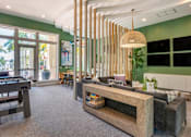 Thumbnail 7 of 28 - A room with a green wall and a wooden table.