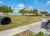 Thumbnail 28 of 28 - A park with a bench, a fire hydrant, and a tree.