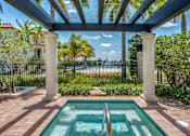 Thumbnail 4 of 28 - A pool surrounded by a black fence and a white pillar.