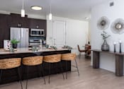Thumbnail 69 of 85 - A kitchen with brown cabinets and a white fridge.