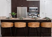Thumbnail 68 of 85 - A kitchen with a bar stool and a countertop.