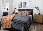 Thumbnail 74 of 85 - A bedroom with a large bed and a ceiling fan.