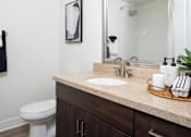 Thumbnail 80 of 85 - A bathroom with a white toilet and a sink.