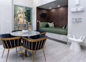 Thumbnail 49 of 85 - A modern dining room with a glass table and chairs.