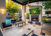 Thumbnail 45 of 85 - A patio with a fireplace and seating area.